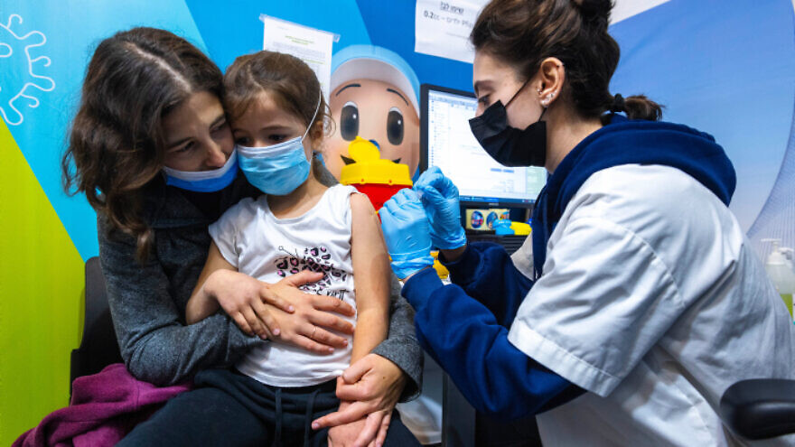 A child receives a COVID-19 vaccination in Jerusalem, Dec. 30, 2021. Photo by Olivier Fitoussi/Flash90.