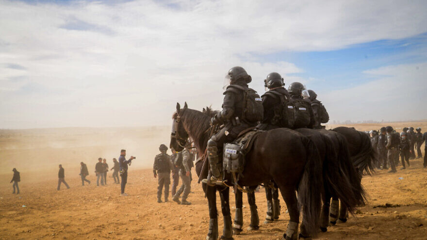 Mounted Israeli police officers responding to a riot outside the Bedouin village of al-Atrash in the Negev, Jan. 12, 2022. Photo by Flash90.