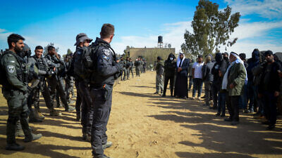 Israeli Police stand guard during a protest against tree-planting by the Jewish National Fund-Keren Kayamet LeIsrael outside the Bedouin village of al-Atrash in the Negev Desert on Jan. 12, 2022. Photo by Flash90.