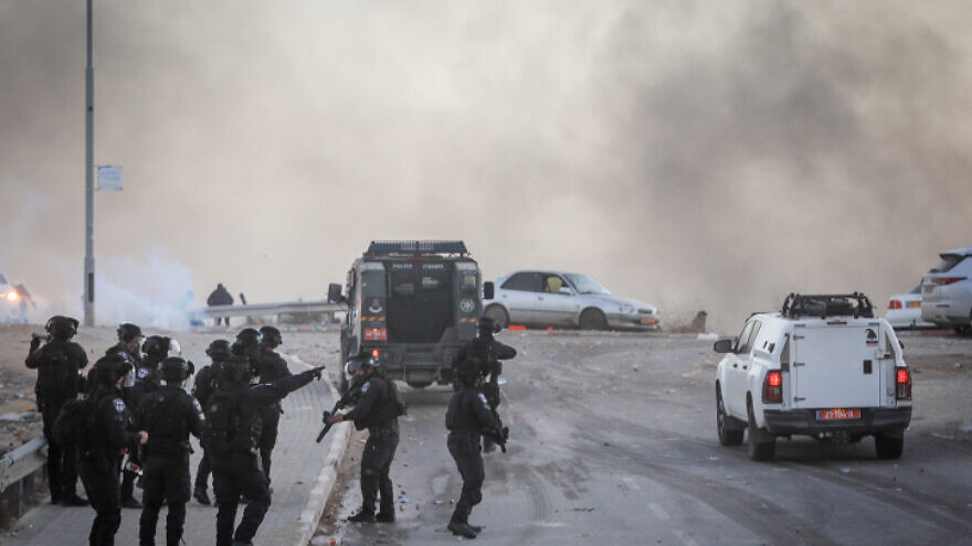 Israeli Police clash with Bedouins during a protest against tree-planting by the Jewish National Fund-Keren Kayamet LeIsrael outside the Bedouin village of al-Atrash in the Negev Desert on Jan. 13, 2022. Photo by Jamal Awad/Flash90.