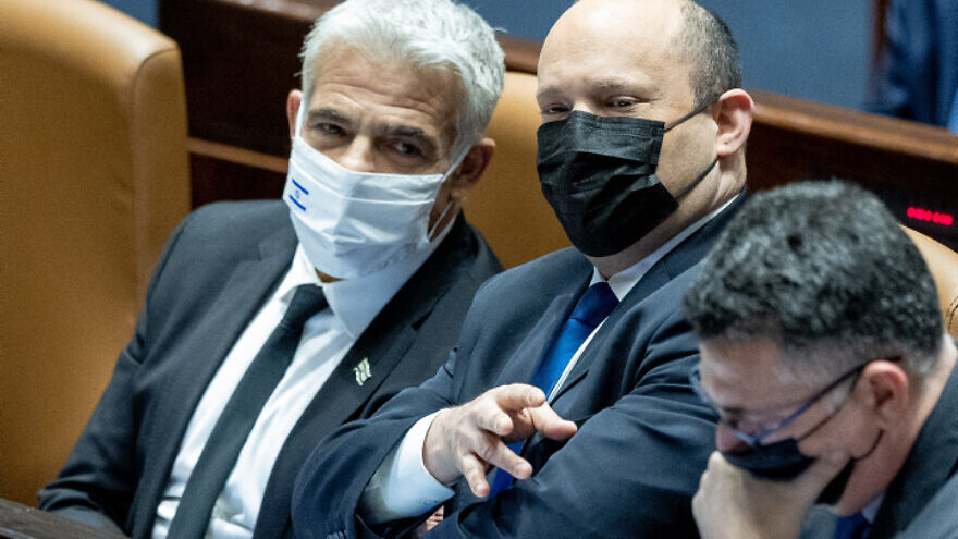 Israeli prime minister Naftali Bennett (center), Foreign Minister Yair Lapid (left) and Justice Minister Gideon Saar in the Knesset assembly hall, Jan. 17, 2022. Photo by Yonatan Sindel/Flash90.