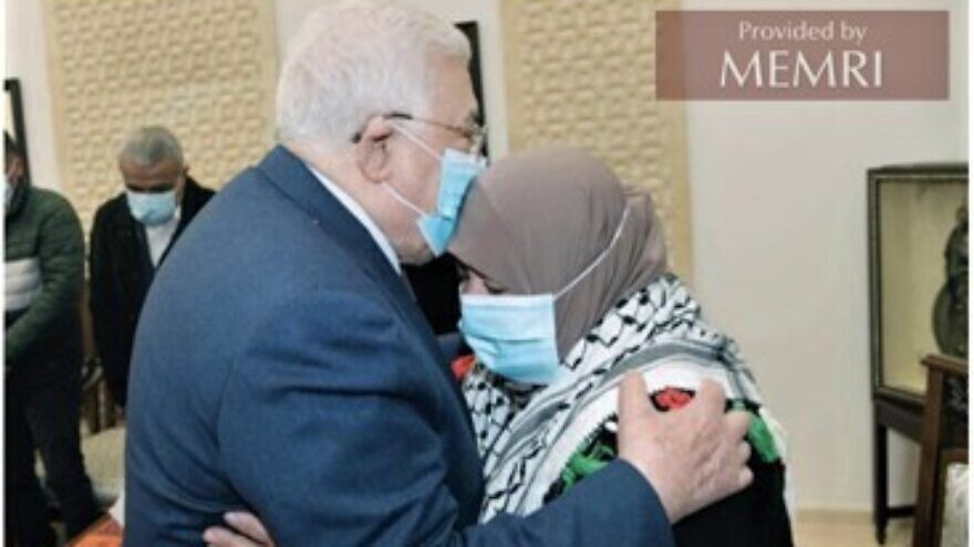 Palestinian Authority leader Mahmoud Abbas embraces Latifa Abu Hmeid, the mother of six terrorists confirmed by Israel, during a meeting in Ramallah on Jan. 12, 2022. Source: Al-Hayat Al-Jadida, Jan. 13, 2022 via MEMRI.