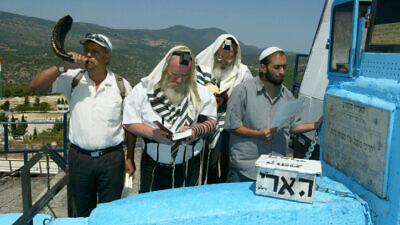 Jews pray at the grave of Rabbi Isaac Luria Ashkenazi in Tzfat, July 2006.
Photo by Haim Azulay/Flash90.