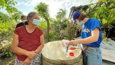 An IsraAID worker tests water quality in Negros, Philippines. Photo by Sunshine Escaro.