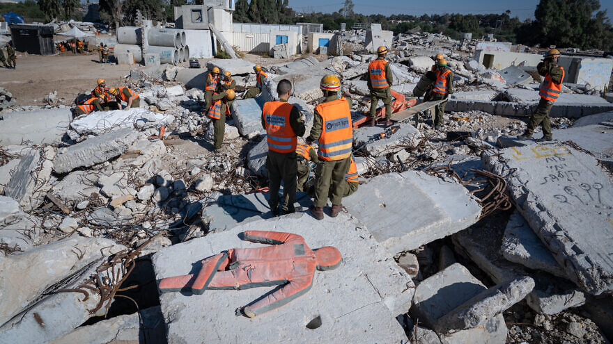 Members of the Knesset Honor Guard, the Israeli Defense Forces Home Front Command, firefighters, police and Israel's Magen David Adom emergency medical services participate in an emergency drill simulating an earthquake near Ashkelon on Dec. 19, 2019. Photo by Yaniv Nadav/Flash90.