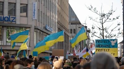 Protesters in Dusseldorf, Germany, rally against Russia's invasion of Ukraine. Credit: Alina Mint/Shutterstock.