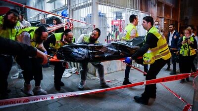 Members of the ZAKA organization remove a body at the scene of a terrorist shooting attack in Bnei Brak on March 29, 2022. Photo by Avshalom Sassoni/Flash90.
