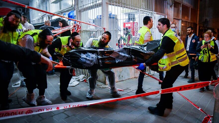 Members of the ZAKA organization remove a body at the scene of a terrorist shooting attack in Bnei Brak on March 29, 2022. Photo by Avshalom Sassoni/Flash90.