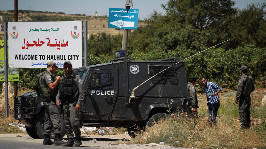 Israeli security forces at the entrance to Halhul, near Hebron in Judea and Samaria, in July 2014. Photo by Hadas Parush/Flash90.