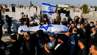 Mourners carry the body of 67-year-old Menahem Yehezkel, who was stabbed to death by a Bedouin Arab during a car-ramming attack in the southern Israeli city of Beersheva on March 22, during his funeral at a Beersheva cemetery on March 23, 2022. Photo by Olivier Fitoussi/Flash90.