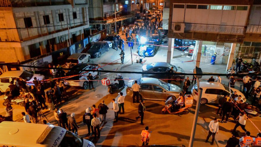 Israeli police officers and rescue forces are seen at the scene of a shooting attack in Bnei Brak on March 29, 2022. Photo by Avshalom Sassoni/Flash90