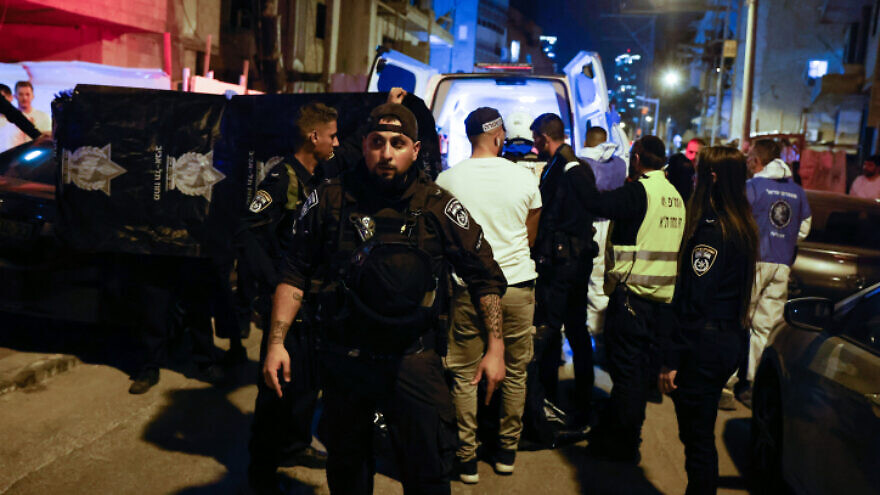 Israeli police officers and rescue forces are seen at the scene of a shooting attack in Bnei Brak, March 29, 2022. Photo by Olivier Fitoussi/Flash90.