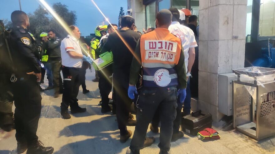 Emergency responders with Magen David Adom treat two Israeli police officers who were stabbed near the Old City of Jerusalem, on March 7, 2022. Source: Twitter.