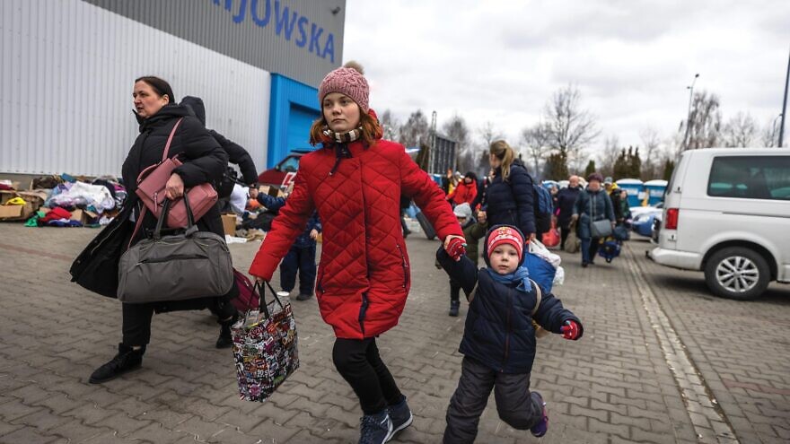 A mother and child who fled the Russian invasion of Ukraine at a temporary accommodation center in Korczowa, Poland. Photo by Olivier Fitoussi/Flash90.