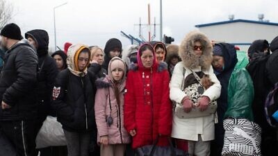 Ukrainian refugees waiting for a bus to take them to safey. Photo by David Isaac.