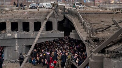 Ukrainian civilians and soldiers take shelter under a bridge in Kyiv, March 5, 2022. Credit: Міністерство внутрішніх справ України via Wikimedia Commons.