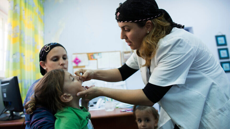 An child is vaccinated at a Children's Medical Center in Neve Yaakov, Jerusalem, Sept. 10, 2013. Photo by Yonatan Sindel/Flash90.