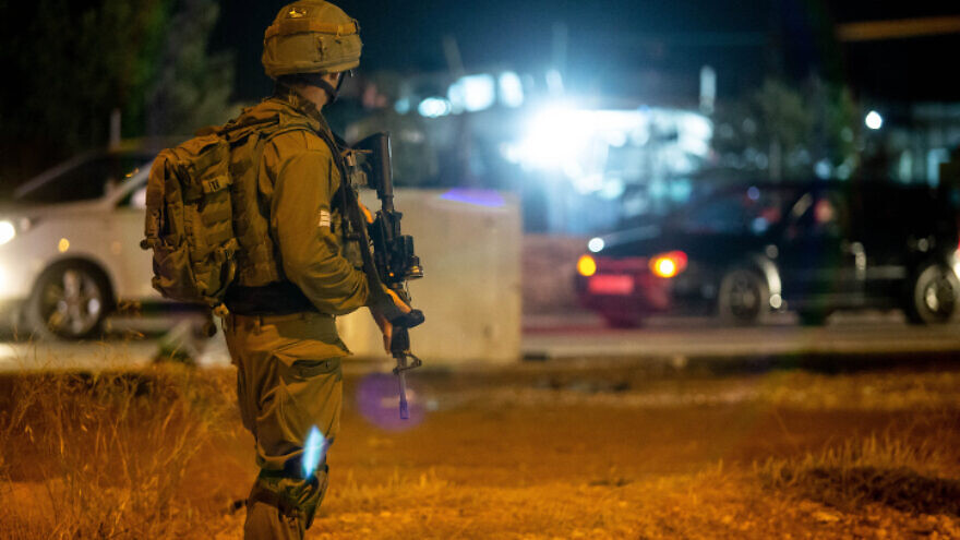 An Israeli soldiers near the scene of a suspected terror attack at the entrance to the village of Husan, west of Bethlehem, on June 23, 2018. Photo by Aharon Krohn/Flash90.