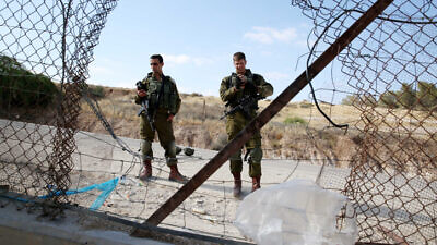 Israeli soldiers at a breach in the security fence, near Hebron, May 23, 2021. Photo by Wisam Hashlamoun.
