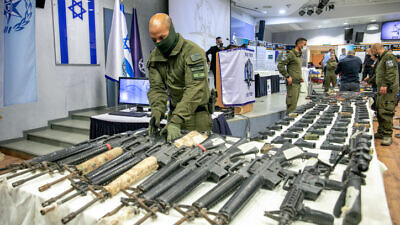 Illegal weapons are displayed after the largest ever Israeli police operation against illegal gun dealers, in Tel Aviv, Nov. 9, 2021. Photo by Yossi Aloni/Flash90.