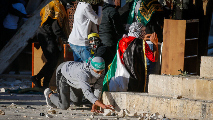 Palestinian rioters hurl stones towards Israeli security forces during Ramadan clashes on the Temple Mount in Jerusalem's Old City on April 15, 2022. Photo by Jamal Awad/Flash90.