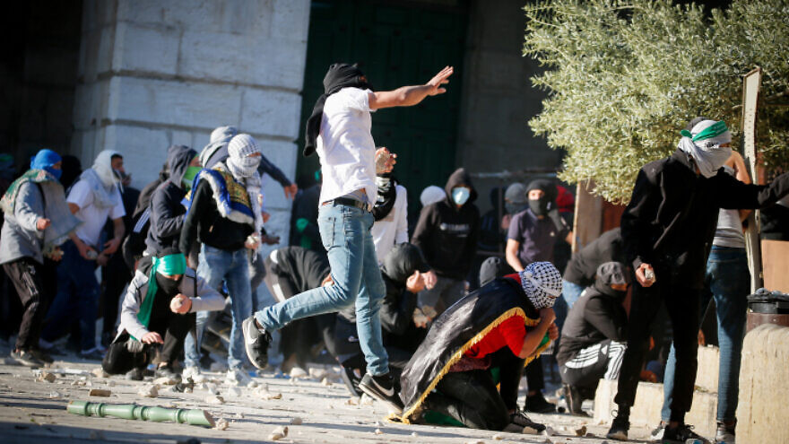 Palestinian rioters hurl stones towards Israeli security forces during Ramadan clashes on the Temple Mount in Jerusalem's Old City, April 15, 2022. Photo by Jamal Awad/Flash90.