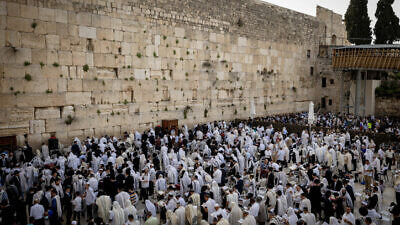Jewish worshippers cover themselves with prayer shawls at the Western Wall (Kotel) in Jerusalem during the Kohanim Benediction for the Jewish holiday of Passover, April 18, 2022. Photo by Yonatan Sindel/Flash90.