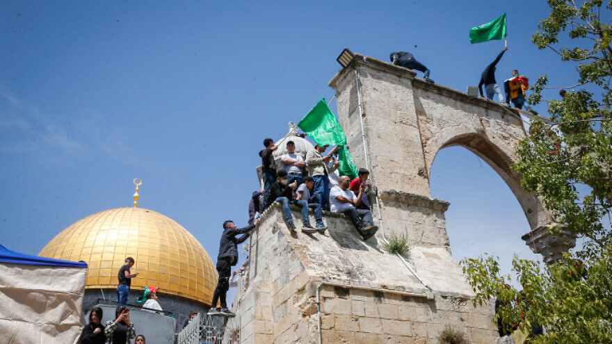 Protesters wave Hamas flags after Friday prayers, at the Al Aqsa mosque compound in Jerusalem's Old City, April 22, 2022. Photo by Jamal Awad/Flash90.