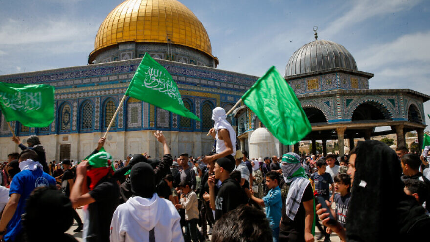 Muslims wave Hamas flags after Friday prayers during Ramadan, on the Temple Mount in Jerusalem, April 22, 2022. Photo by Jamal Awad/Flash90.