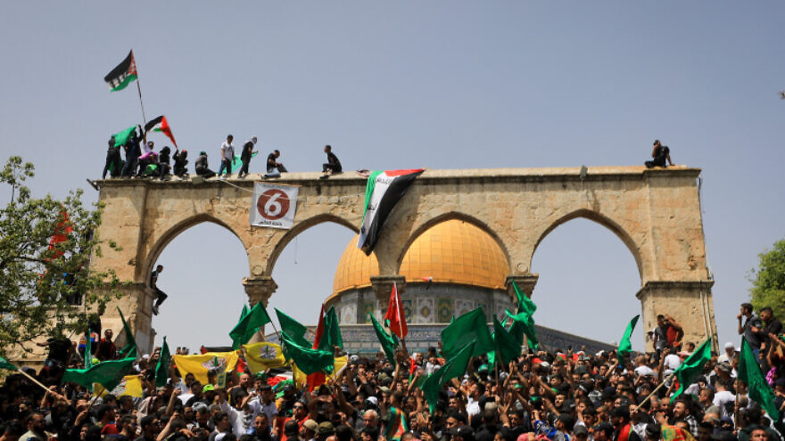 Arabs wave flags and chant anti-Israel slogans at the Al-Aqsa mosque on the Temple Mount in Jerusalem on the last Friday of Ramadan, April 29, 2022. Photo by Jamal Awad/Flash90.