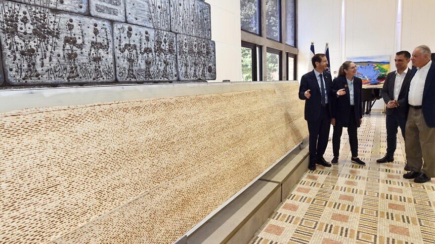 Israeli President Isaac Herzog views the largest matzah in Israel, at the President's Residence on April 10, 2022. Credit: Haim Zach/GPO.