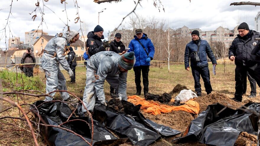 Forensic police officers exhume bodies in Bucha, on the outskirts of Kyiv, Ukraine. April 12, 2022