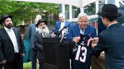 Jewish philanthropist Robert Kraft inaugurates a new yeshivah in New England to educate an initial eight rabbis, as Rabbi Shlomo Noginski (left) and Rabbi Dan Rodkin (second from left), director of Shaloh House, a Chabad-affiliated school and Jewish community center in the Boston area, and other donors look on, May 19, 2022. Credit: Olga Mariotti/Chabad.org News.