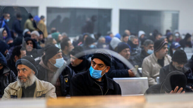 Palestinian workers wait at the Erez border crossing in the northern Gaza Strip, March 13, 2022. Photo by Attia Muhammed/Flash90.
