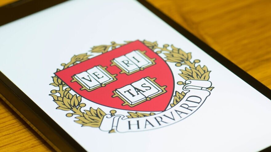 A smartphone showing the logo of Harvard University. Credit: g0d4ather/Shutterstock.
