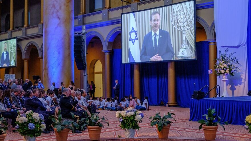 Israeli President Isaac Herzog displayed on a screen speaking to guests at Israel’s 74th Independence Day held in the atrium of the National Building Museum in Washington, D.C., on May 12, 2022. Photo by Dmitriy Shapiro.
