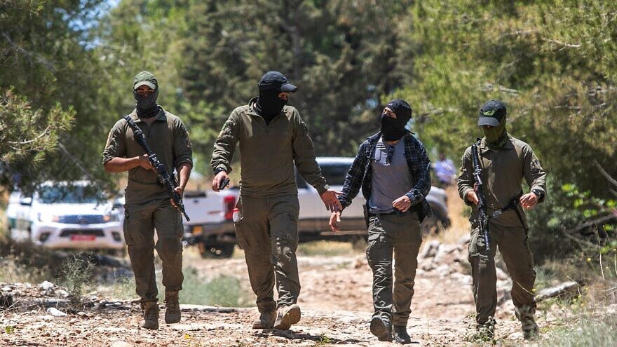 Israeli security forces in a forested area near the city of Elad, where two Palestinians who carried out a deadly terror attack there last week were arrested, May 8, 2022. Photo by Yossi Aloni/Flash90.