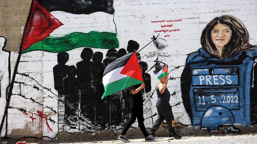 Palestinians walk past a mural of journalist Shireen Abu Akleh in the West Bank city of Bethlehem, on May 16, 2022. Photo by Wisam Hashlamoun/Flash90.