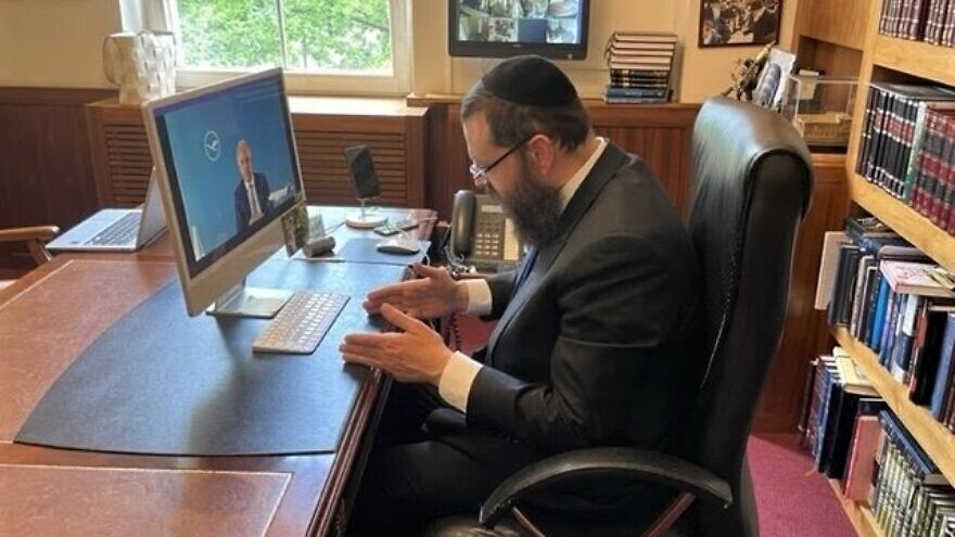 Rabbi Yehuda Teichtal on a video call with Lufthansa CEO Carsten Spohr, who pledged to fight anti-Semitism within the company, May 11, 2022. Credit: Courtesy of Chabad Berlin.