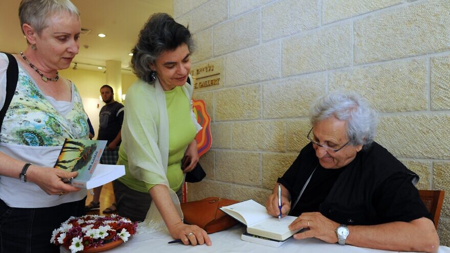 A.B. Yehoshua autographs one of his novels at the International Writers Festival at Mishkenot Sha'ananim in Jerusalem in 2010. Credit: Moshe Milner/The Israel National Photo Collection.