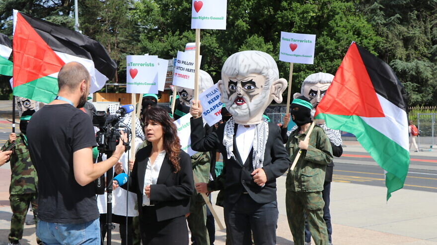 Israel Defense Forces reservists protest outside the U.N. Human Rights Council in Geneva, costumed as terrorists to “thank” the council for its anti-Israel bias in a demonstration organized by the Tel Aviv-based Shurat HaDin Law Center on June 7, 2022. Credit: Courtesy.