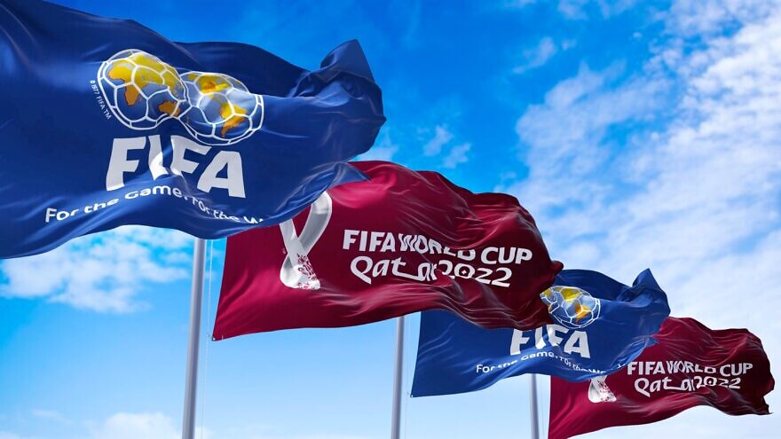 Flags with FIFA and Qatar 2022 World Cup logo waving in the wind. Credit: rarrarorro/Shutterstock.
