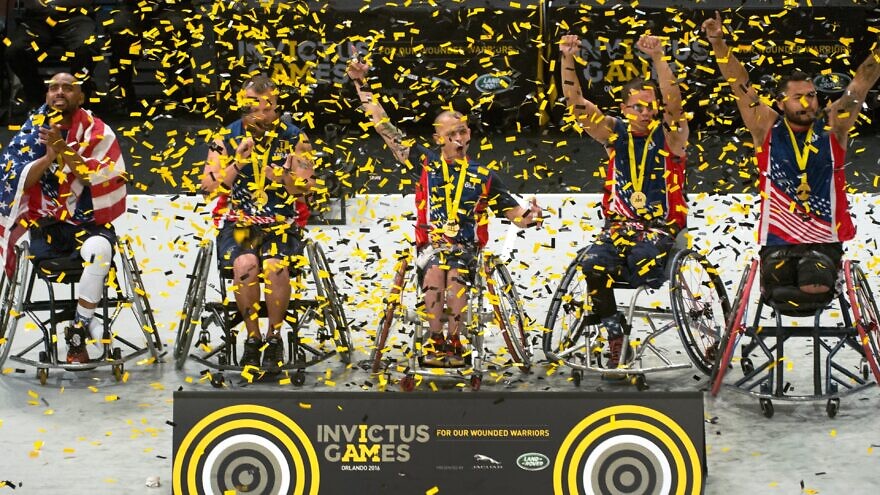 U.S. Invictus wheelchair basketball team members celebrate their gold-medal win during the 2016 Invictus Games in Orlando, Fla., on May 12, 2016. Credit: U.S. Department of Defense Photo Edward Joseph Hersom II via Wikimedia Commons.