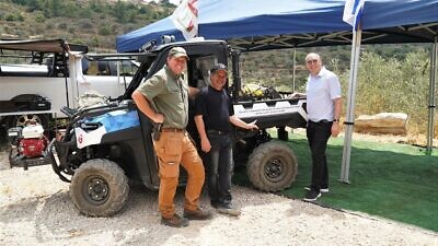 From left: Binyamin Security Division Ya'acov Dolev; Vision for Israel founder and Sarvadi family representative Barry Segal; and Israel Magen Fund founder David Rose, at the inauguration of a firefighting ATV for the Shiloh area on June 28, 2022. Credit: Courtesy of Itamar Segev.