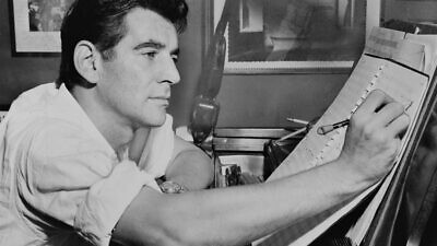 American Jewish composer Leonard Bernstein seated at piano, making annotations to a musical score, 1955. Credit: Al Ravenna, World Telegram Staff Photographer via Wikimedia Commons.