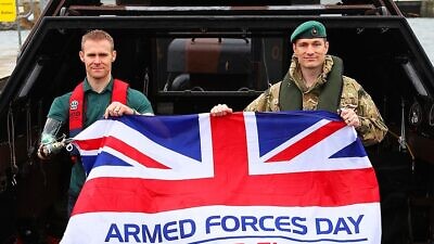 Royal Marine Mark Ormrod and Lieutenant Colonel Nik Cavil with an Armed Forces Day flag at RMB Stonehouse, March 29, 2017. Credit: Dave Gallagher via Wikimedia Commons.