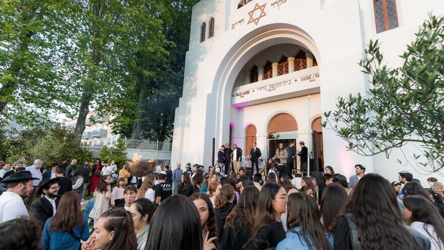 Members of the Jewish congregation stand outside the Kadoorie Mekor Haim Synagogue in Oporto, Portual. Credit: CIP/Bizarro