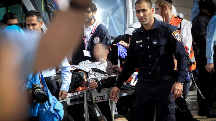 Israeli medics and emergency personnel evacuate a wounded Israeli from the scene of a stabbing in the Jerusalem neighborhood of Pisgat Zeev. Nov. 10, 2015. Photo by Muammar Awad/Flash90.
