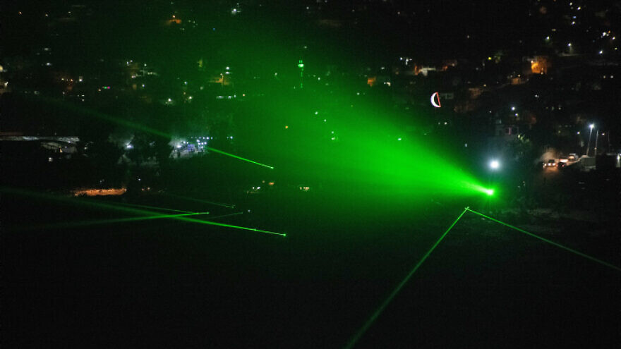 Palestinians flash laser beams towards the illegal Israeli outpost of Evyatar, in Judea and Samaria, on June 29, 2021. Photo by Sraya Diamant/Flash90.
