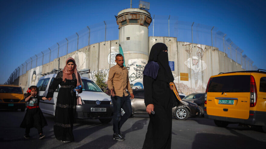 Palestinians make their way through an Israeli checkpoint near Bethlehem to attend Friday prayers at Jerusalem's Al-Aqsa mosque, April 29, 2022. Photo by Wisam Hashlamoun/Flash90.
